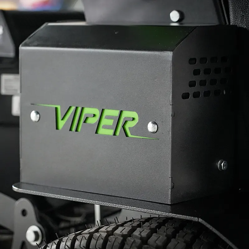 A black metal Viper-branded machine housing with green lettering, mounted above a rugged tire and mechanical components.